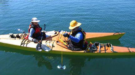 Friends of Green Lake members Gayle Garman and Richard Fleming take water samples and collect information on water conditions from two kayaks positioned side-by-side as part of the King County Lakes and Streams Monitoring Group (formerly Lake Stewarship Program).